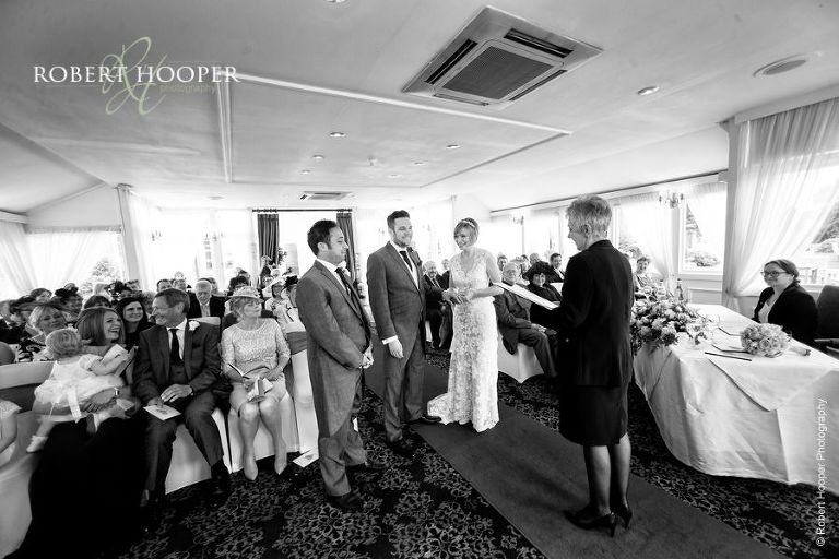 Bride and groom during civil ceremony in orangery at Chilston Park Hotel Miadstone Kent
