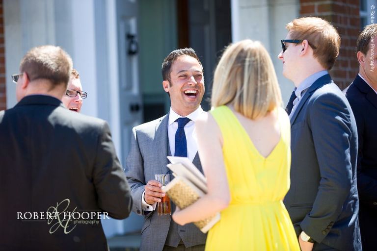 Wedding guests enjoying champagne reception on wedding day at Chilston Park Hotel Maidstone Kent