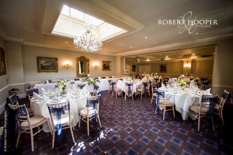 Wedding breakfast room with blue theme at Chilston Park Maidstone Kent