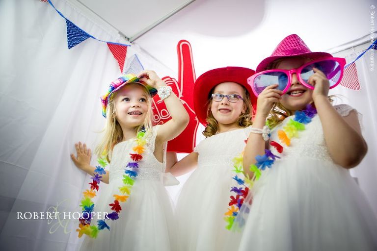 Flower girls dress up for photo booth on wedding day at Chilston Park Maidstone Kent