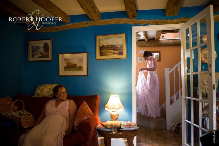 Bridesmaids getting ready for wedding ceremony in The Cottage at the Crown Inn Pishill Oxfordshire