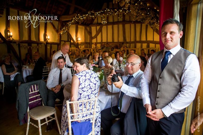 Wedding guests listening to speeches during wedding breakfast at The Crown Inn Pishill Oxfordshire