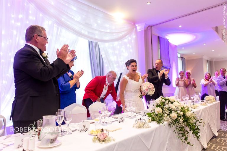 Bride and groom enter for wedding breakfast on wedding day at Wotton House Surrey