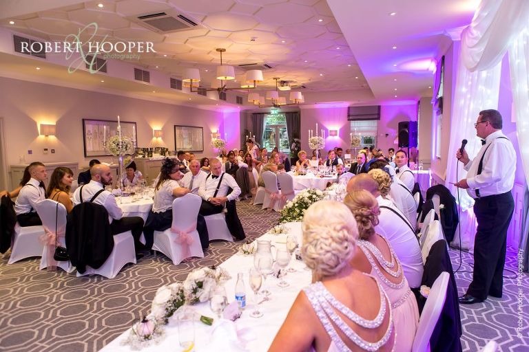 Wedding guests laughing at speeches during wedding breakfast at Wotton House Dorking Surrey