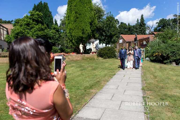Bride arriving to wedding hall at Indian wedding at Shree Swaminarayan Temple London