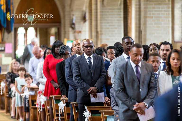Wedding guests awaiting the arrival of the bride on wedding day at St John the Divine Church South Croydon Surrey
