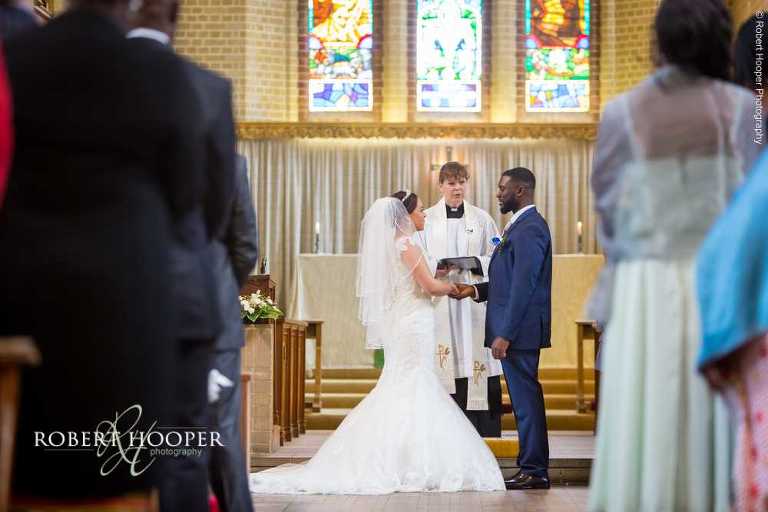 Bride and groom say their wedding vows during wedding ceremony at St John the Divine church in South Croydon Surrey