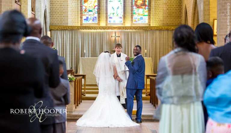 Groom celebrates having just wed his bride at St John the Divine South Croydon Surrey