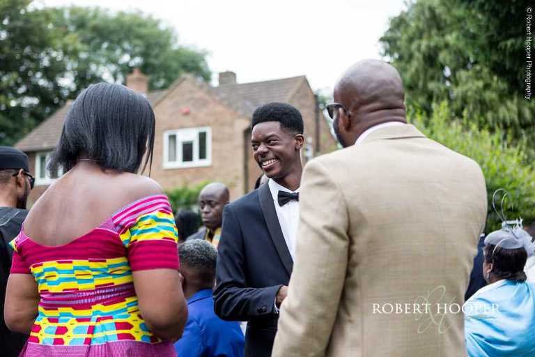 Wedding guests outside St John the Divine Church on wedding day South Croydon Surrey