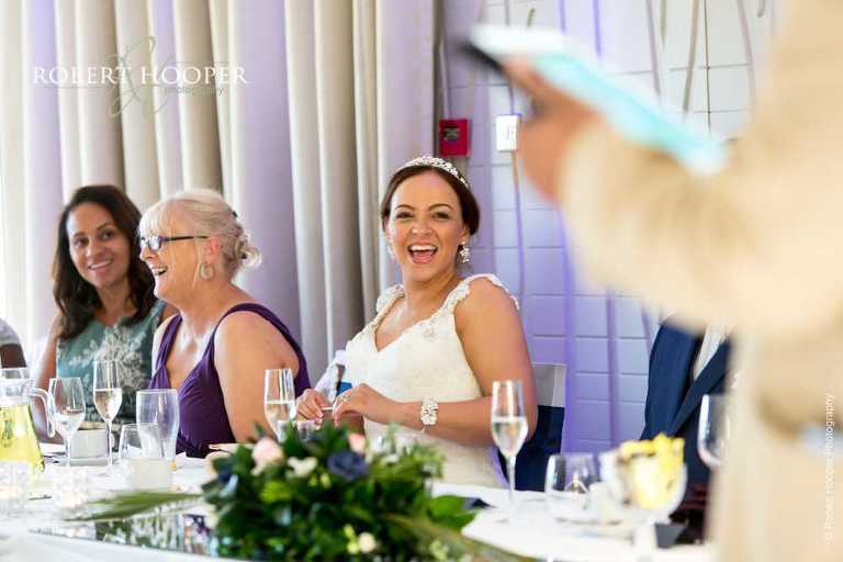 Bride laughing at speech on wedding day at Farleigh Golf Club Warlingham Surrey