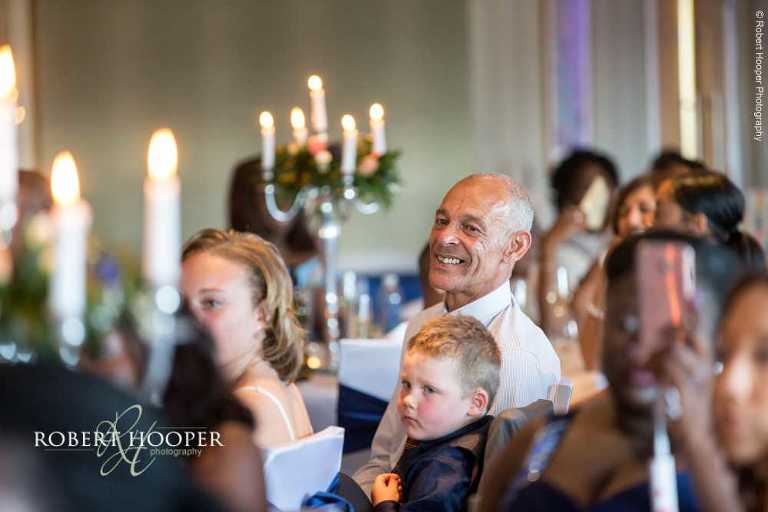 Guests laughing at speeches at wedding breakfast at Farleigh Golf Club Warlingham Surrey