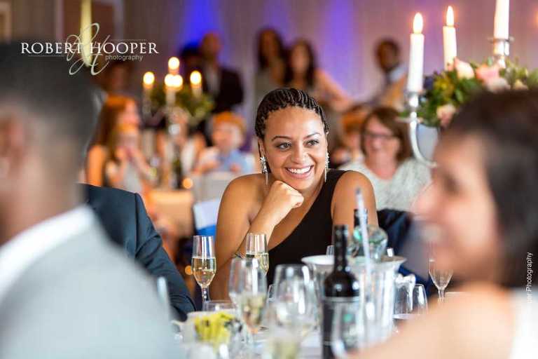 Guests laughing at speeches at wedding breakfast at Farleigh Golf Club Warlingham Surrey