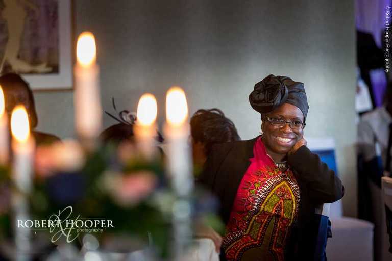 Guests laughing at speeches at wedding breakfast at Farleigh Golf Club Warlingham Surrey