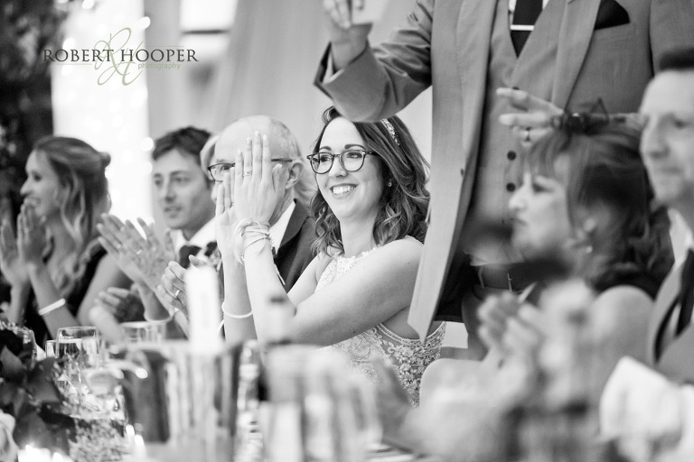 bride clapping during speeches at Denbies Wine Estate