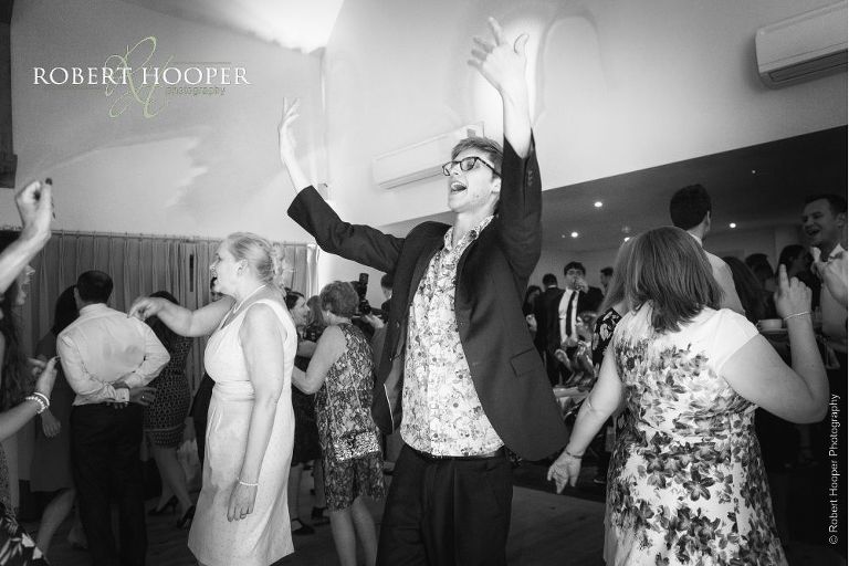 Guests dancing at evening wedding disco at Millbridge Court Frensham Surrey