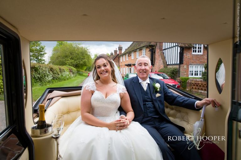 bride with dad in open top vintage car