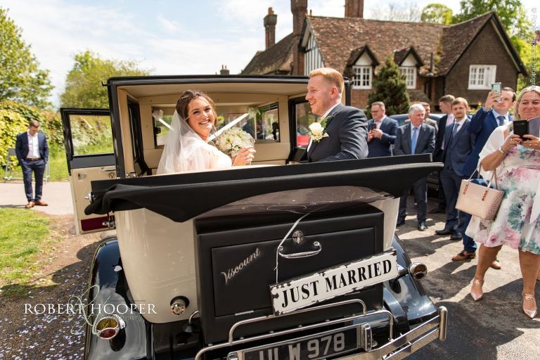 bride and groom in vintage car