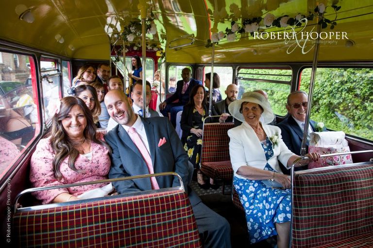 wedding guests on red London bus