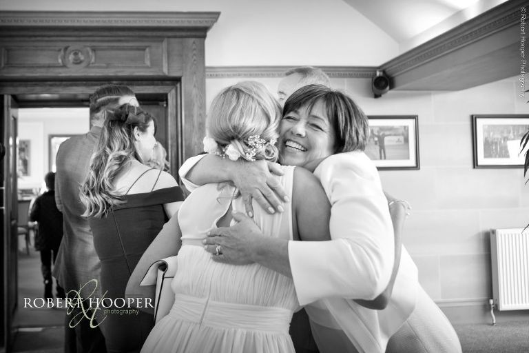 mum hugging bridesmaid