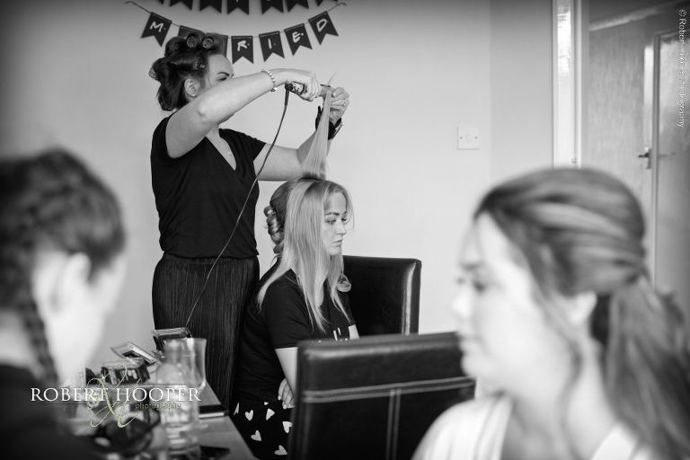 bridesmaid having hair done for wedding