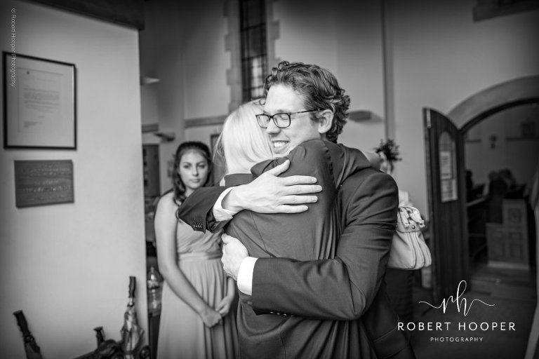 groom hugs guest